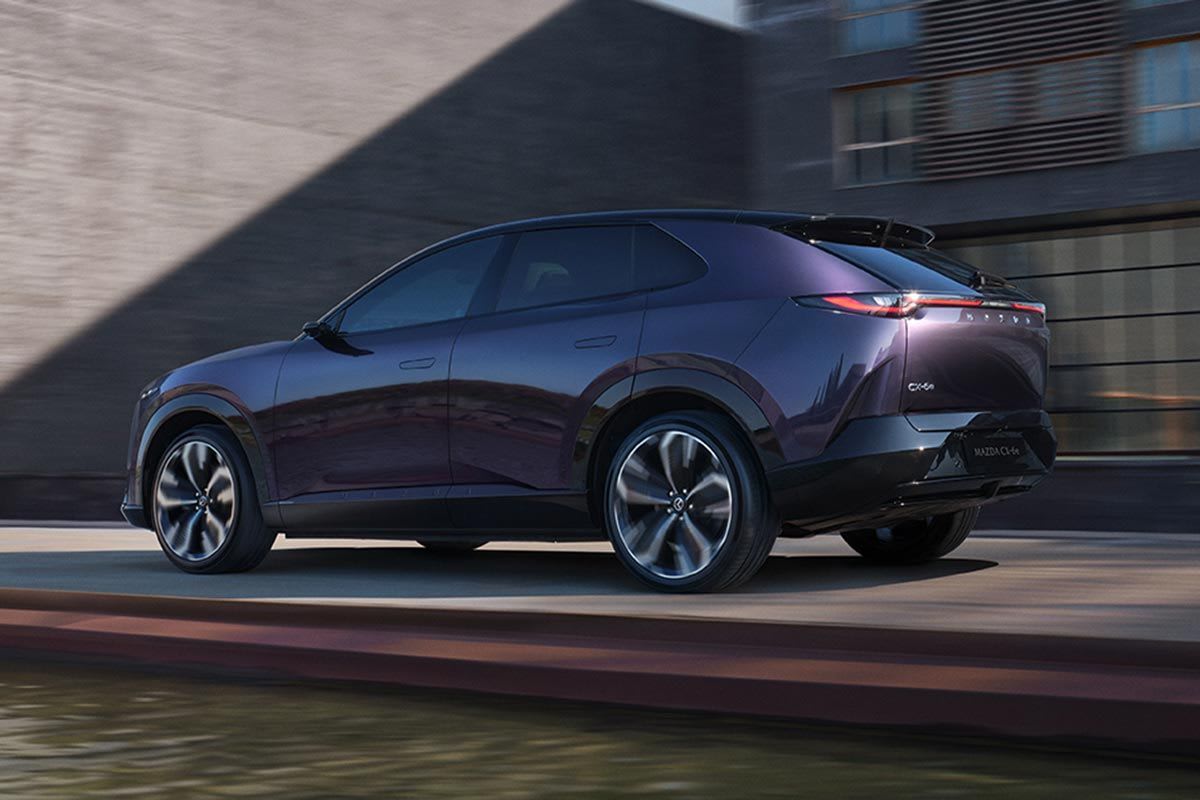 Rear three quarter view of a Nightfall Violet all-electric Mazda CX-6e SUV