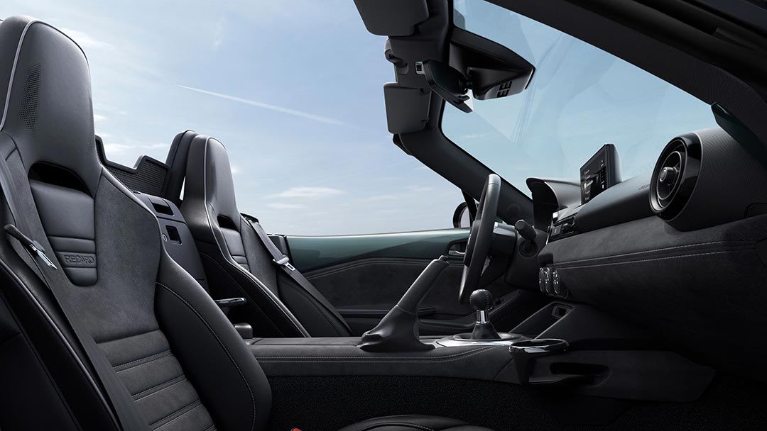 Side view of the front seats and dashboard of the Mazda MX-5 Roadster Takami with Recaro seats