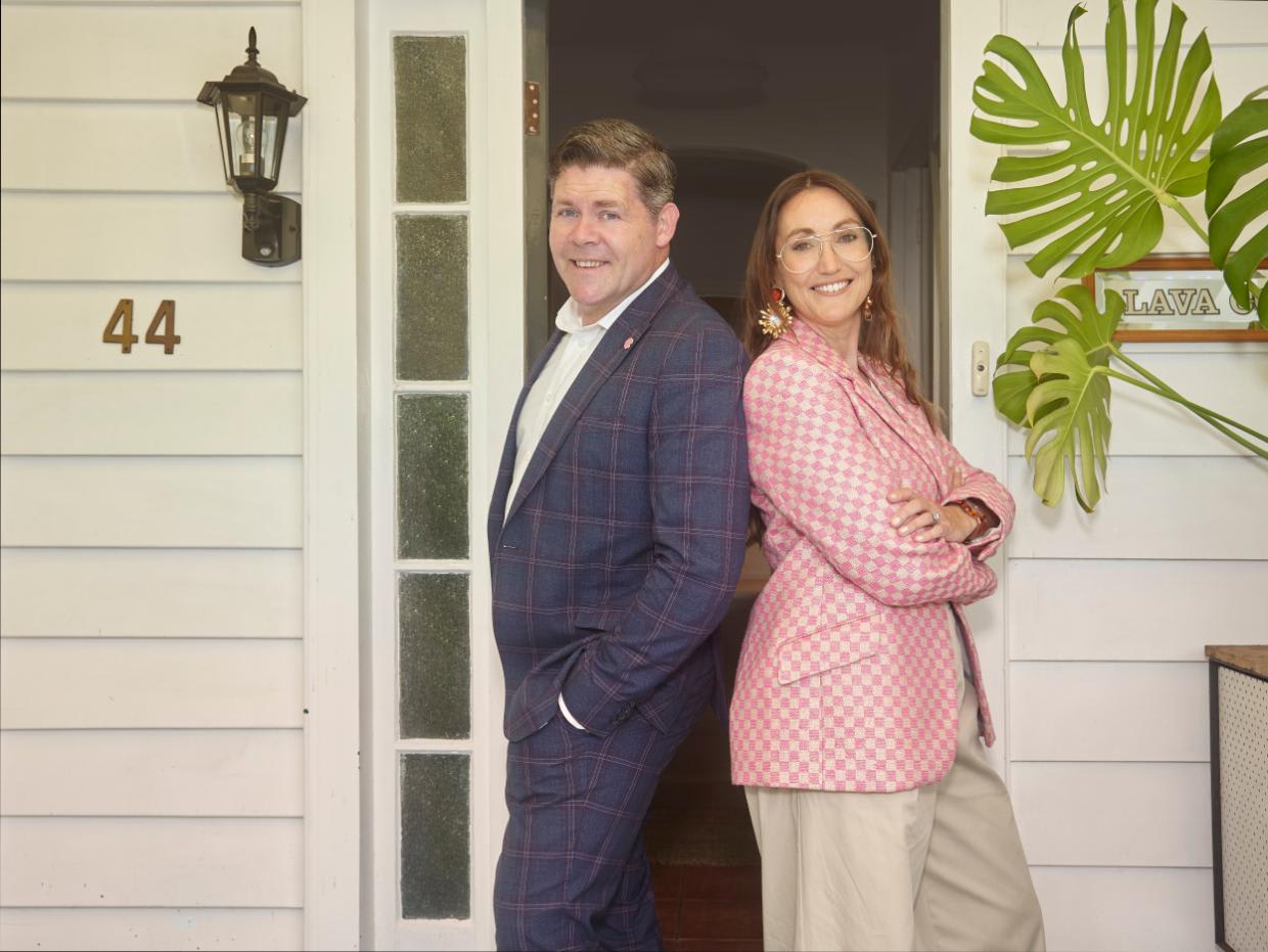 Paul Glover and Alex Walls, the hosts of Love It Or List It NZ, pose together outside of a house.