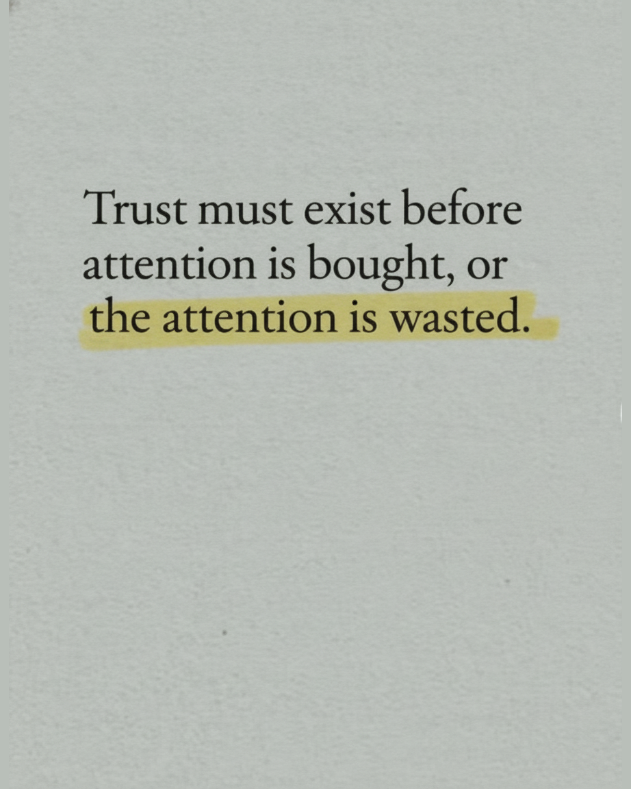 Grey paper page reading Trust must exist before attention is bought, or the attention is wasted, with the final line highlighted in mustard yellow