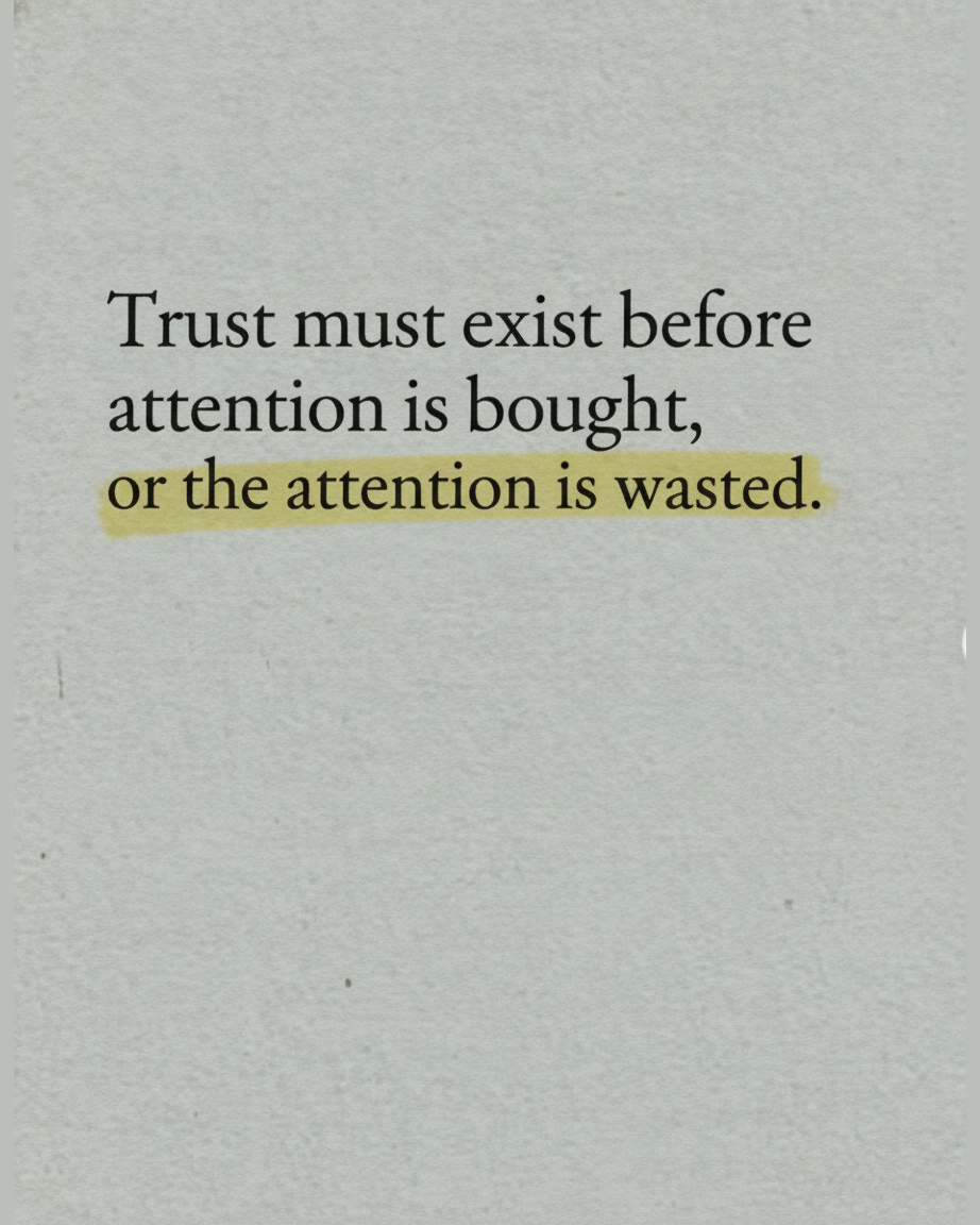 Grey paper page reading Trust must exist before attention is bought, or the attention is wasted, with the attention is wasted highlighted in yellow