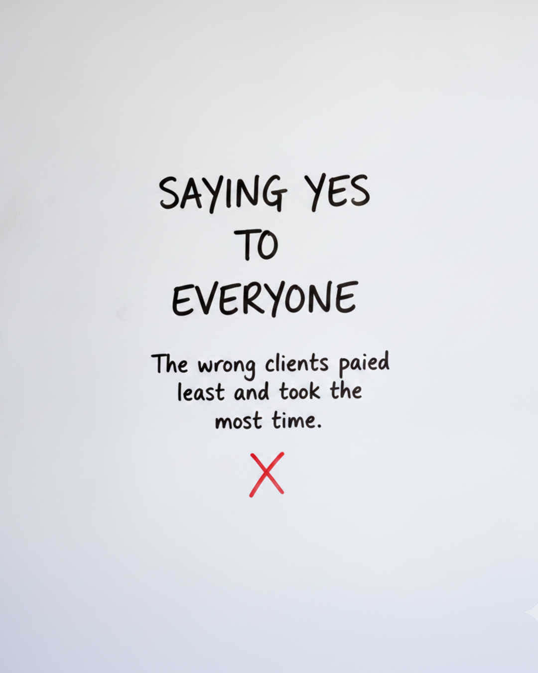 Whiteboard with the words Saying yes to everyone in black marker above a red cross