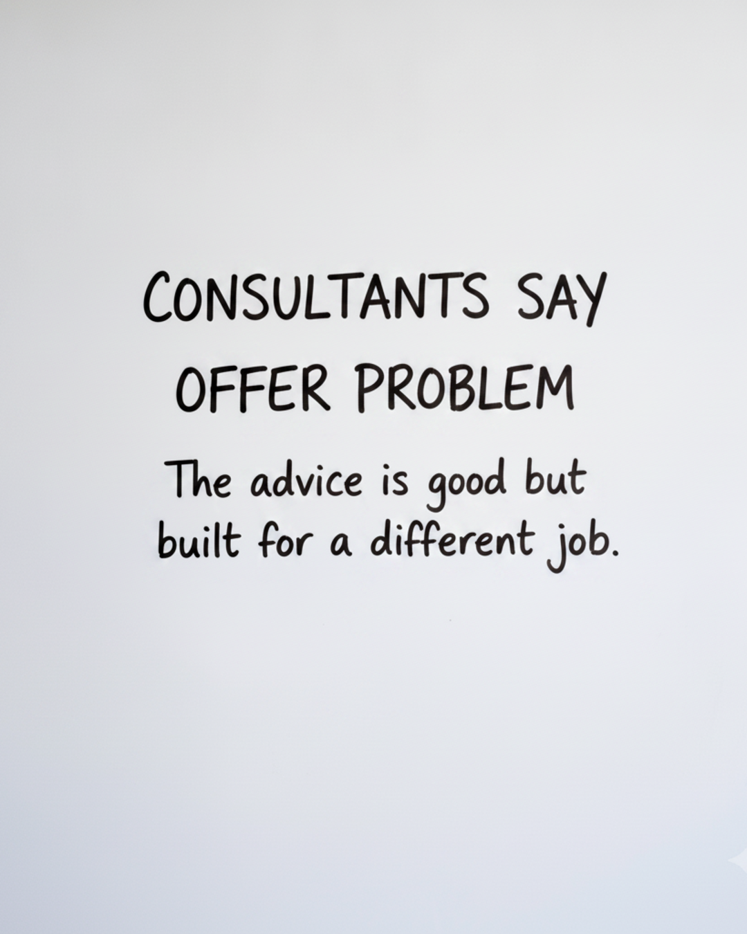 Whiteboard with the words CONSULTANTS SAY OFFER PROBLEM written large in black marker