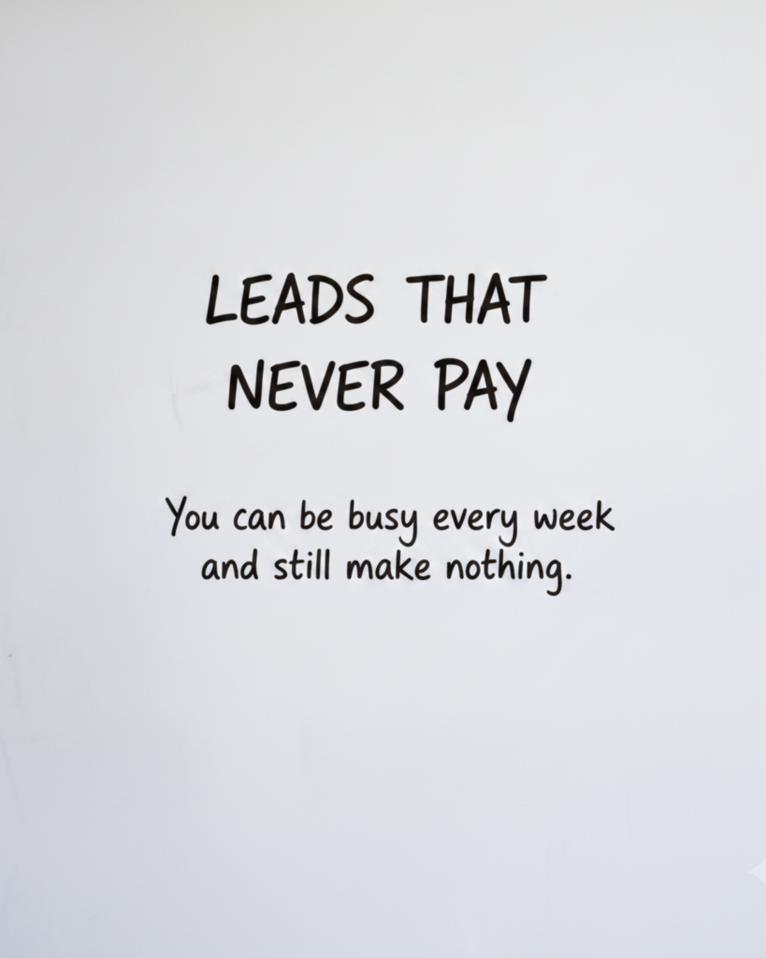 Whiteboard with the words LEADS THAT NEVER PAY written in black marker
