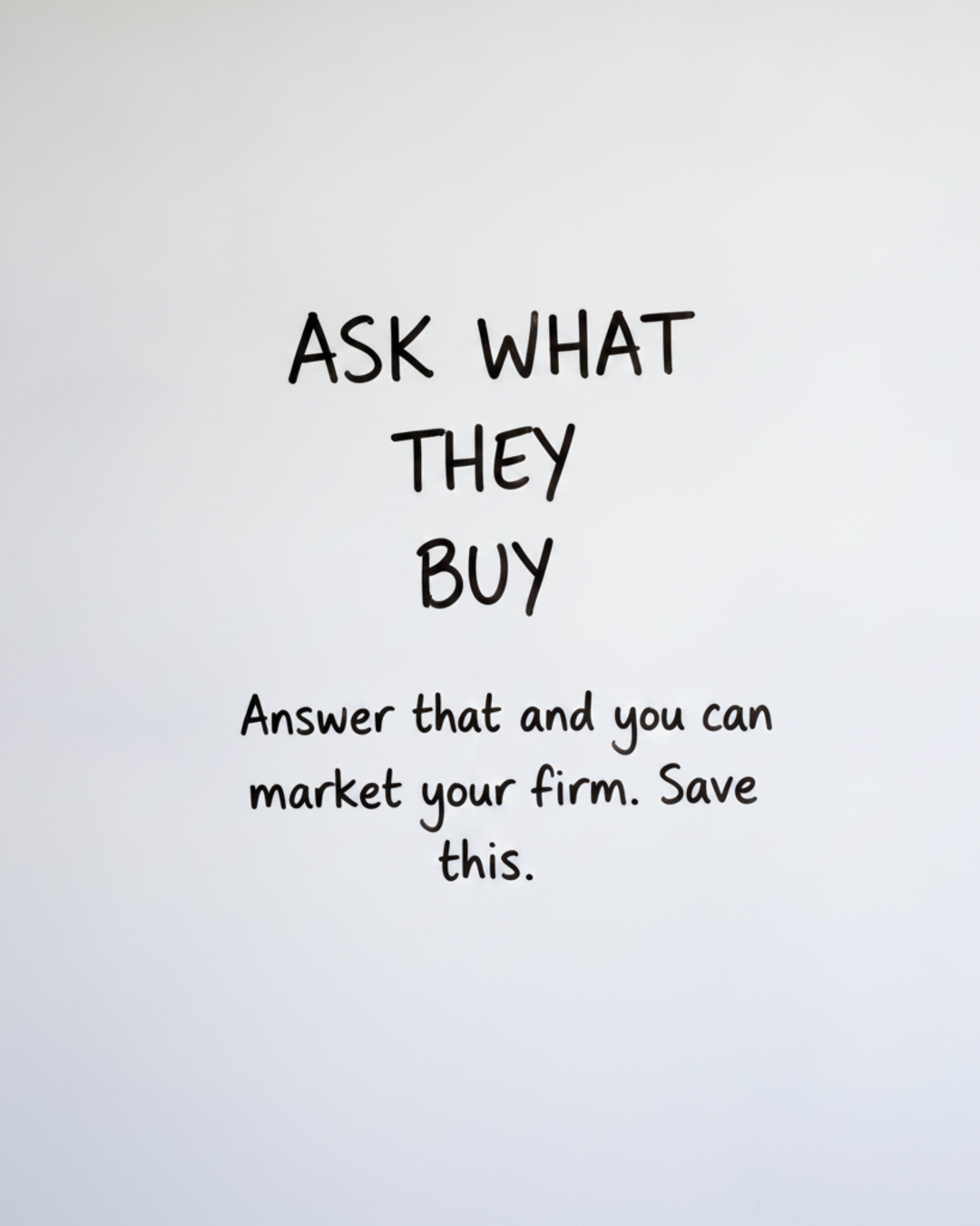 Whiteboard with the words Ask what they buy written in black marker, text only