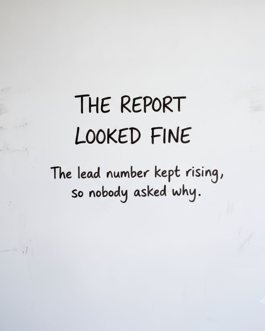 Whiteboard with the words THE REPORT LOOKED FINE written in black marker
