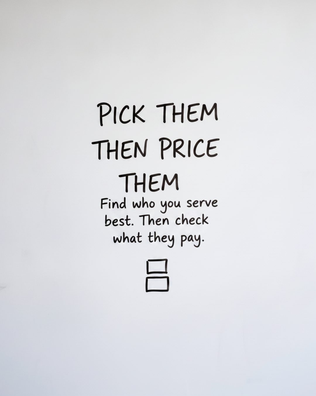 Whiteboard with the words Pick them then price them in black marker above two small stacked boxes