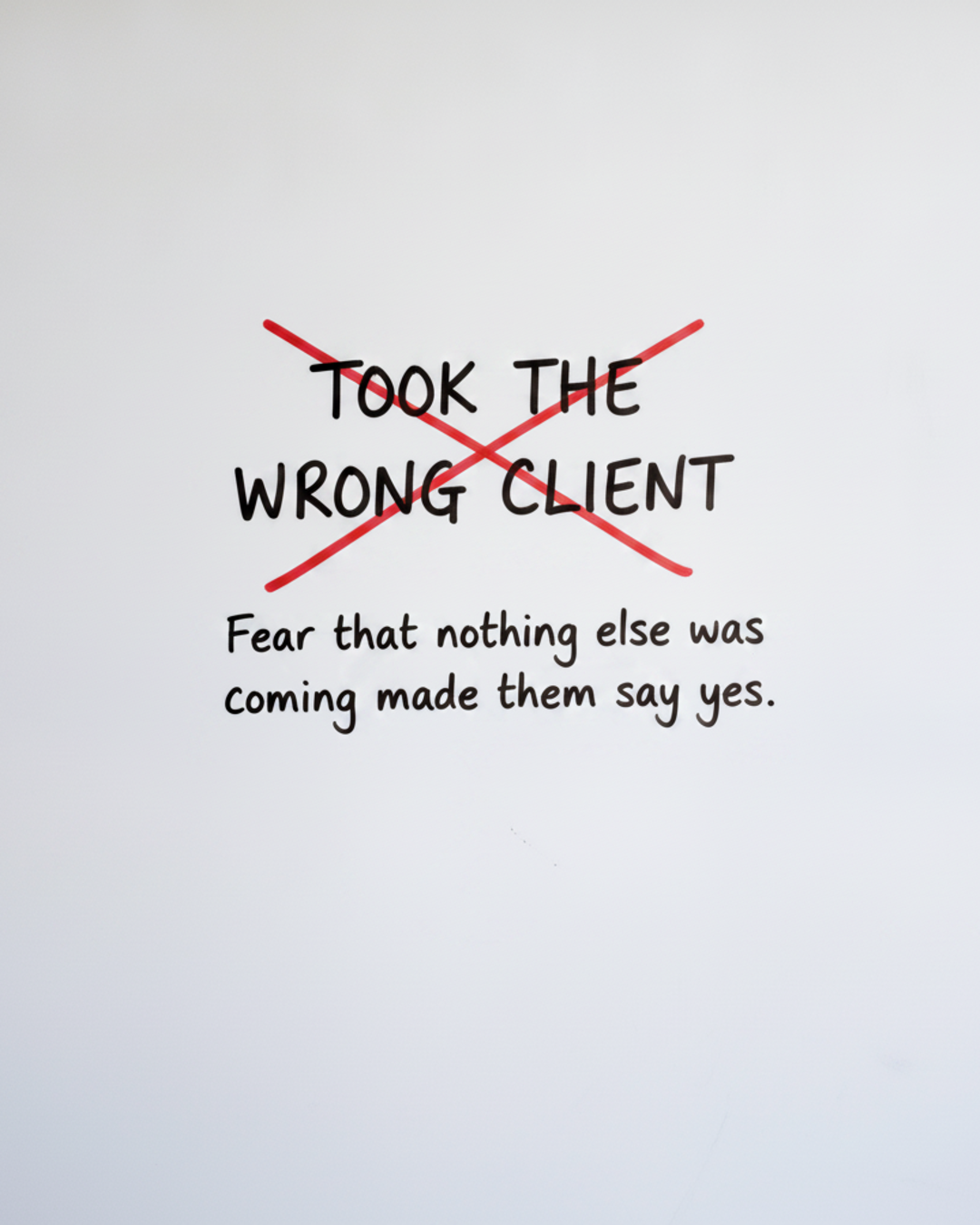 Whiteboard with the words Took the wrong client written in black marker with a red cross struck through it