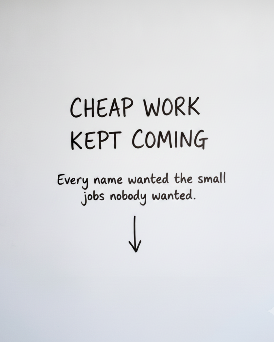 Whiteboard with the words CHEAP WORK KEPT COMING written in black marker above a downward arrow