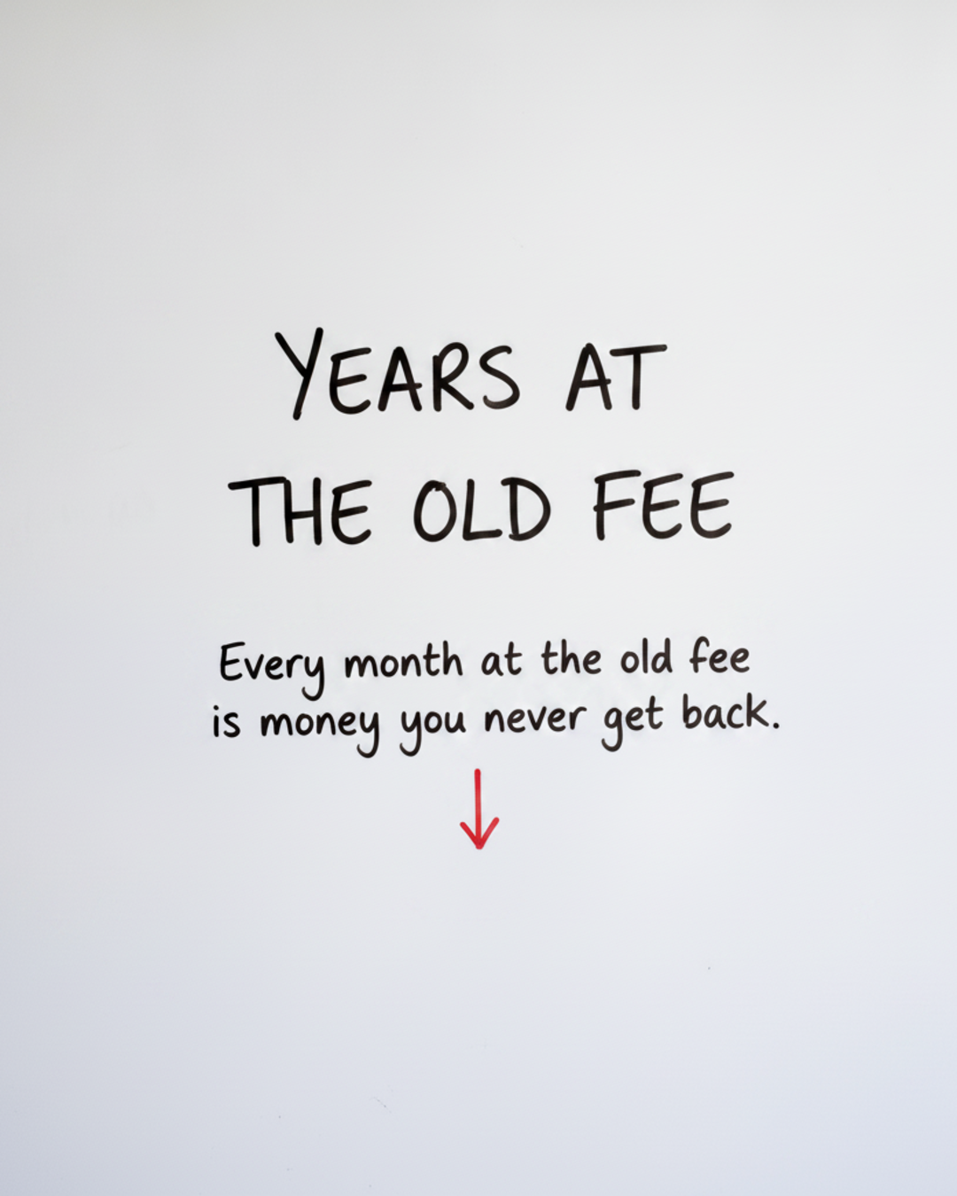 Whiteboard with the words YEARS AT THE OLD FEE written in black marker above a red downward arrow