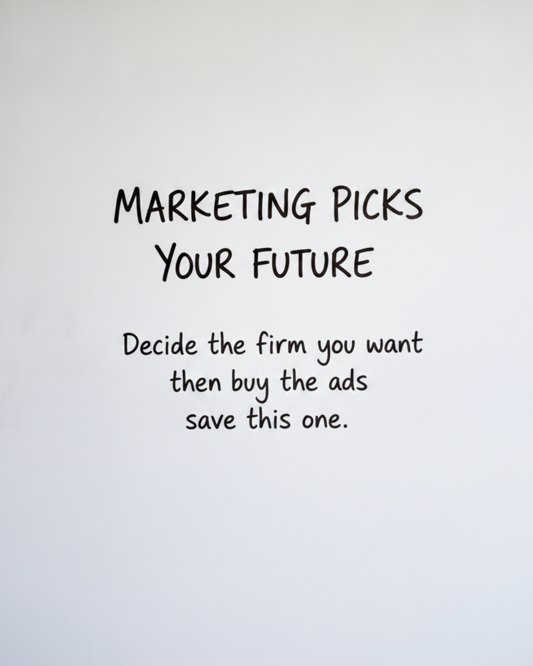 Whiteboard with the words MARKETING PICKS YOUR FUTURE written in black marker