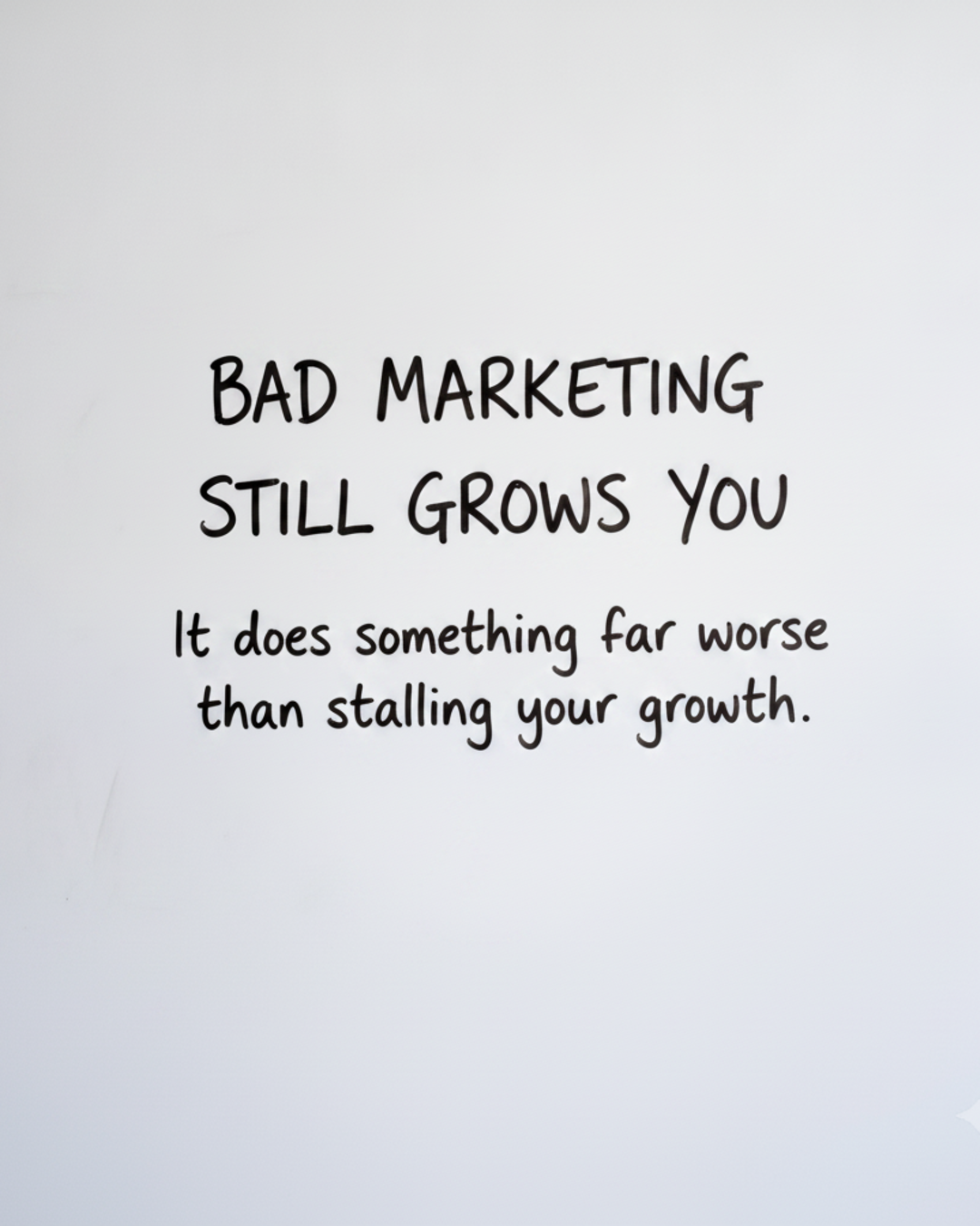 Whiteboard with the words Bad marketing still grows you written in black marker