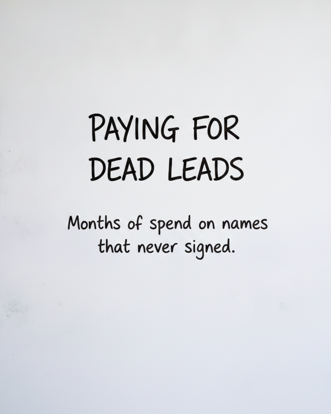 Whiteboard with the words Paying for dead leads written in black marker, above the line Months of spend on names that never signed