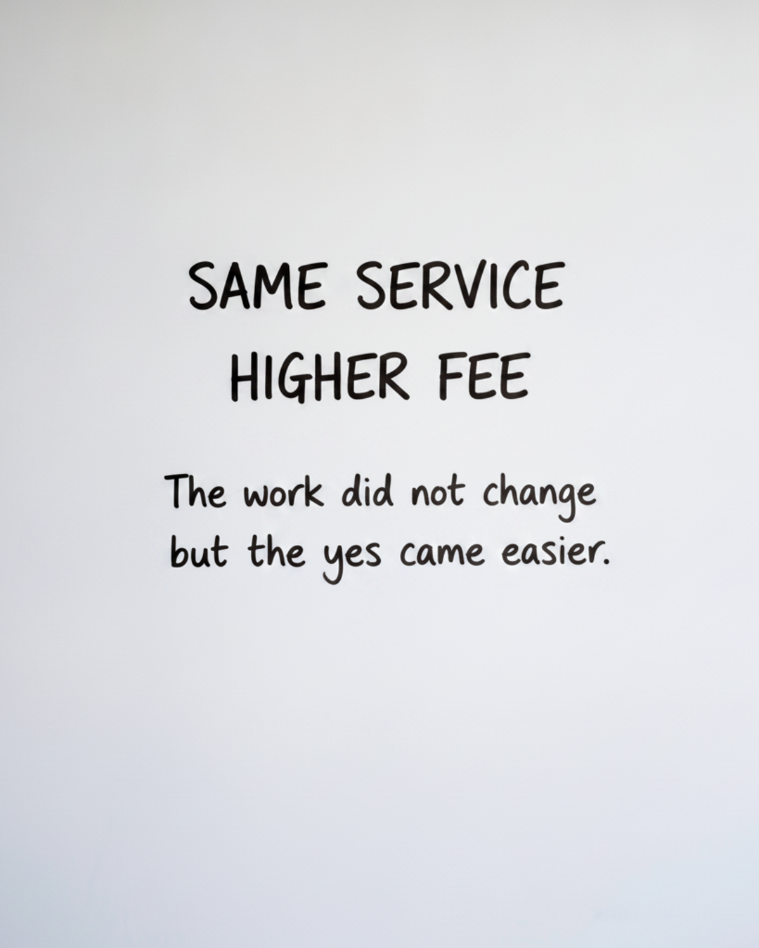 Whiteboard with the words SAME SERVICE HIGHER FEE written large in black marker