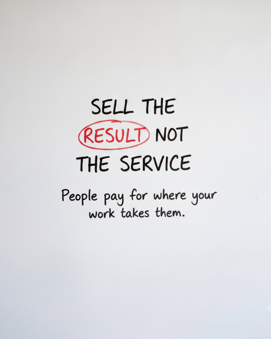 Whiteboard with the words Sell the result not the service, with the word RESULT circled in red marker