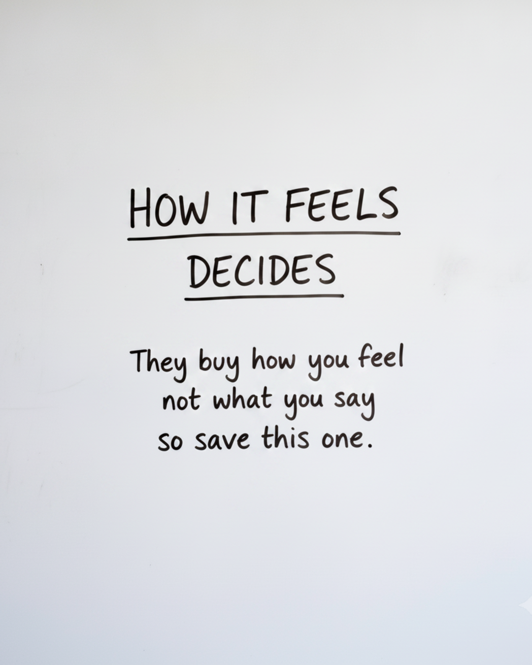 Whiteboard with the words HOW IT FEELS DECIDES written in black marker, with the word FEELS circled in red