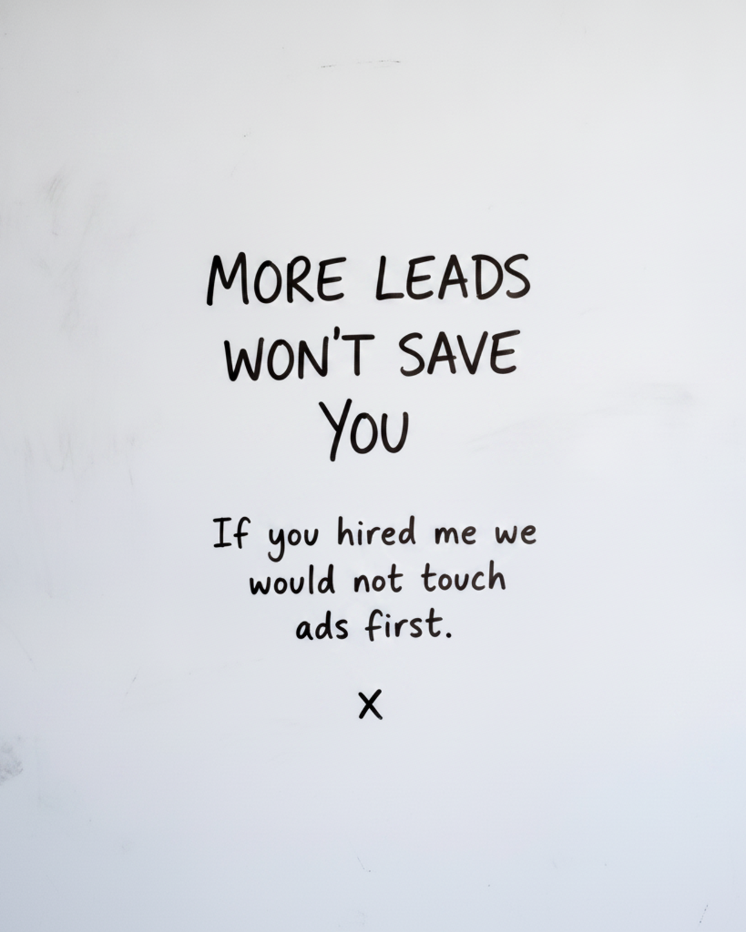 Whiteboard with the words More leads wont save you written in black marker above a smaller line about not touching ads first