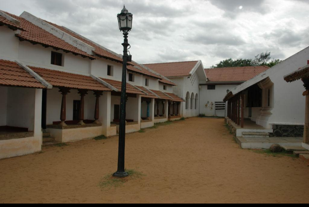 Agraharam-style row houses with tiled roofs and front verandas.