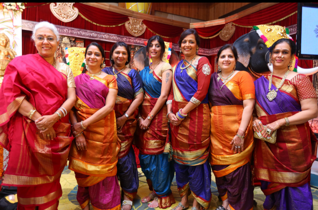 Women in the nine-yard madisar sari at a family function.