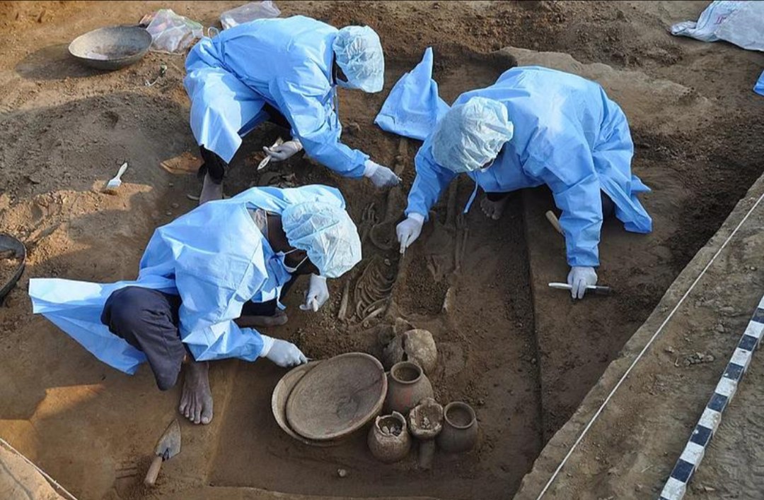Figure 6. Excavating a burial at Rakhigarhi. The team wear protective suits so that their own DNA does not get onto the skeleton.