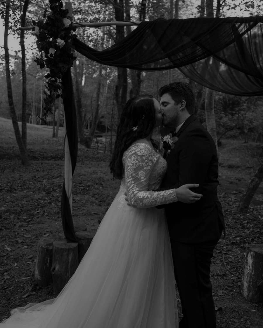 Nick and Makenzie kissing, in black and white