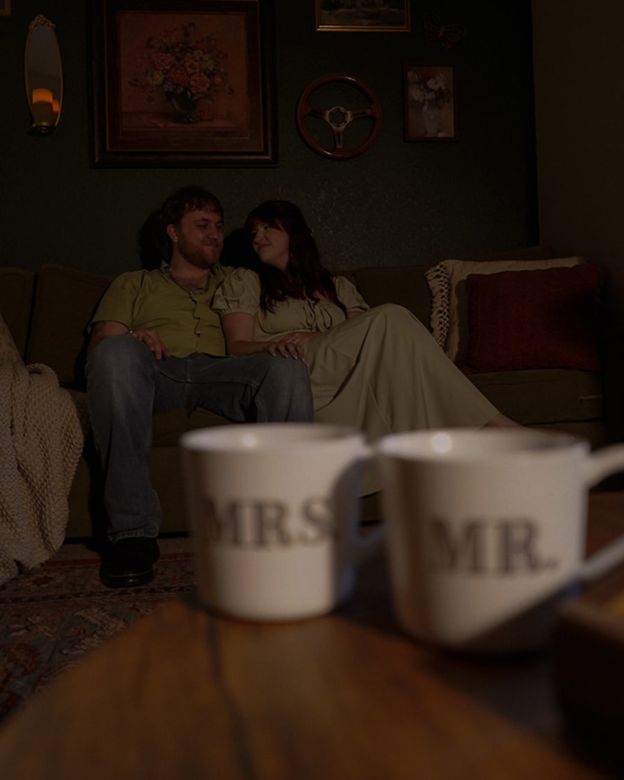 A couple on a couch with mugs