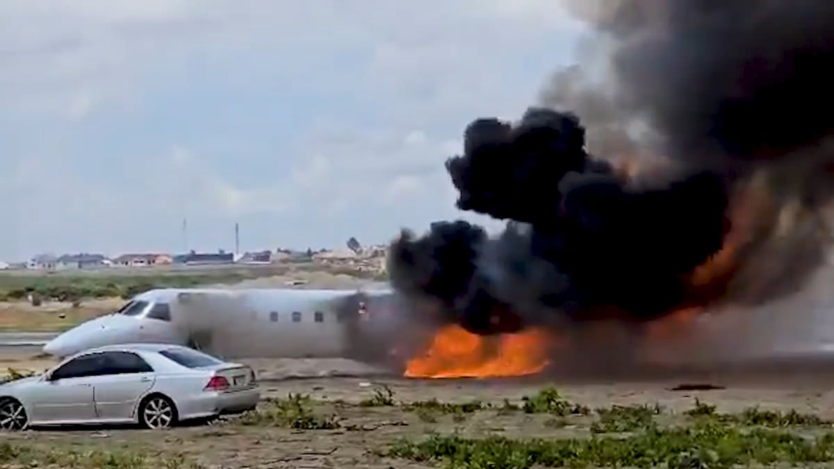 Moment minister's jet bursts into flame as it crashes after shooting off the runway while landing in Democratic Republic of Congo