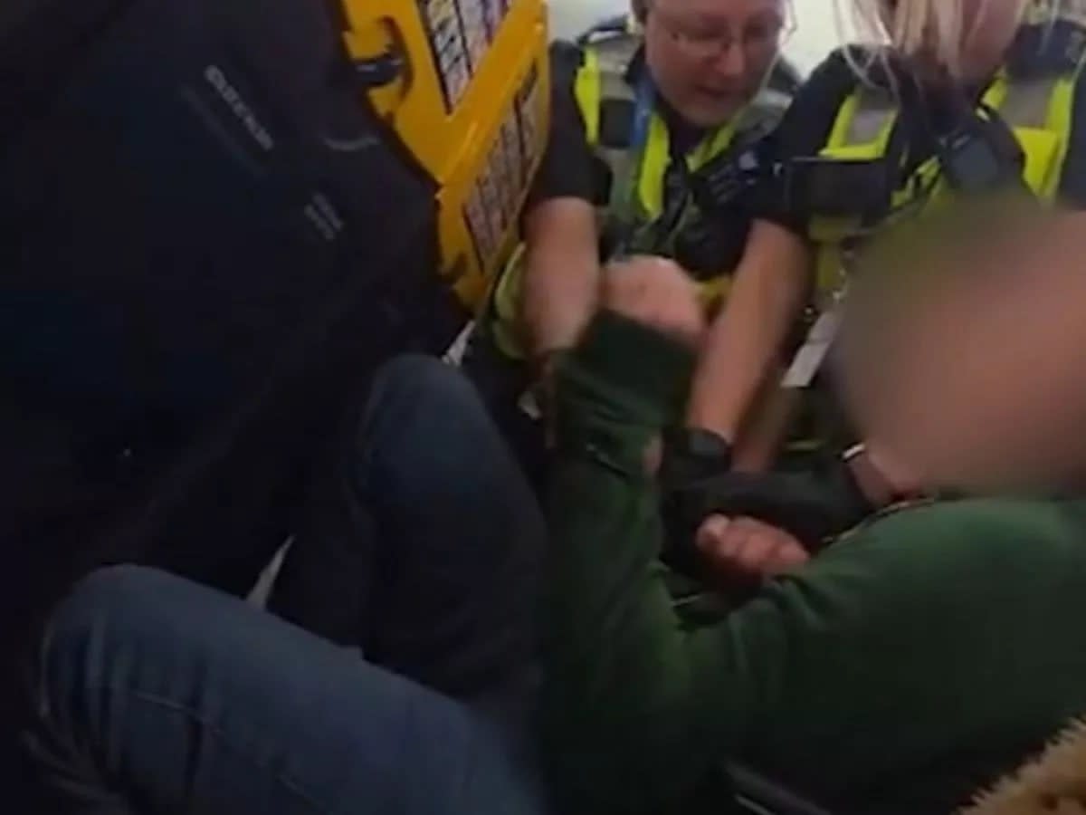 Moment Ryanair passenger clashes with cops after 'refusing to sit down'