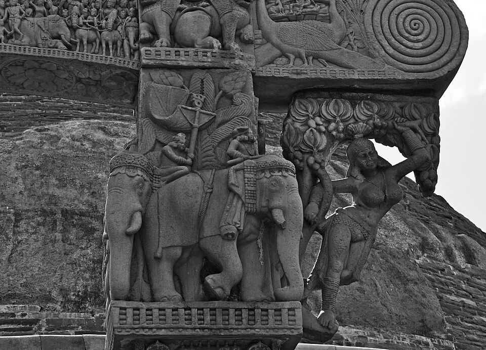 Carved torana (gateway) relief at the Great Stupa, Sanchi, showing a Yakshini figure and elephant procession — Mauryan-Shunga era Buddhist art
