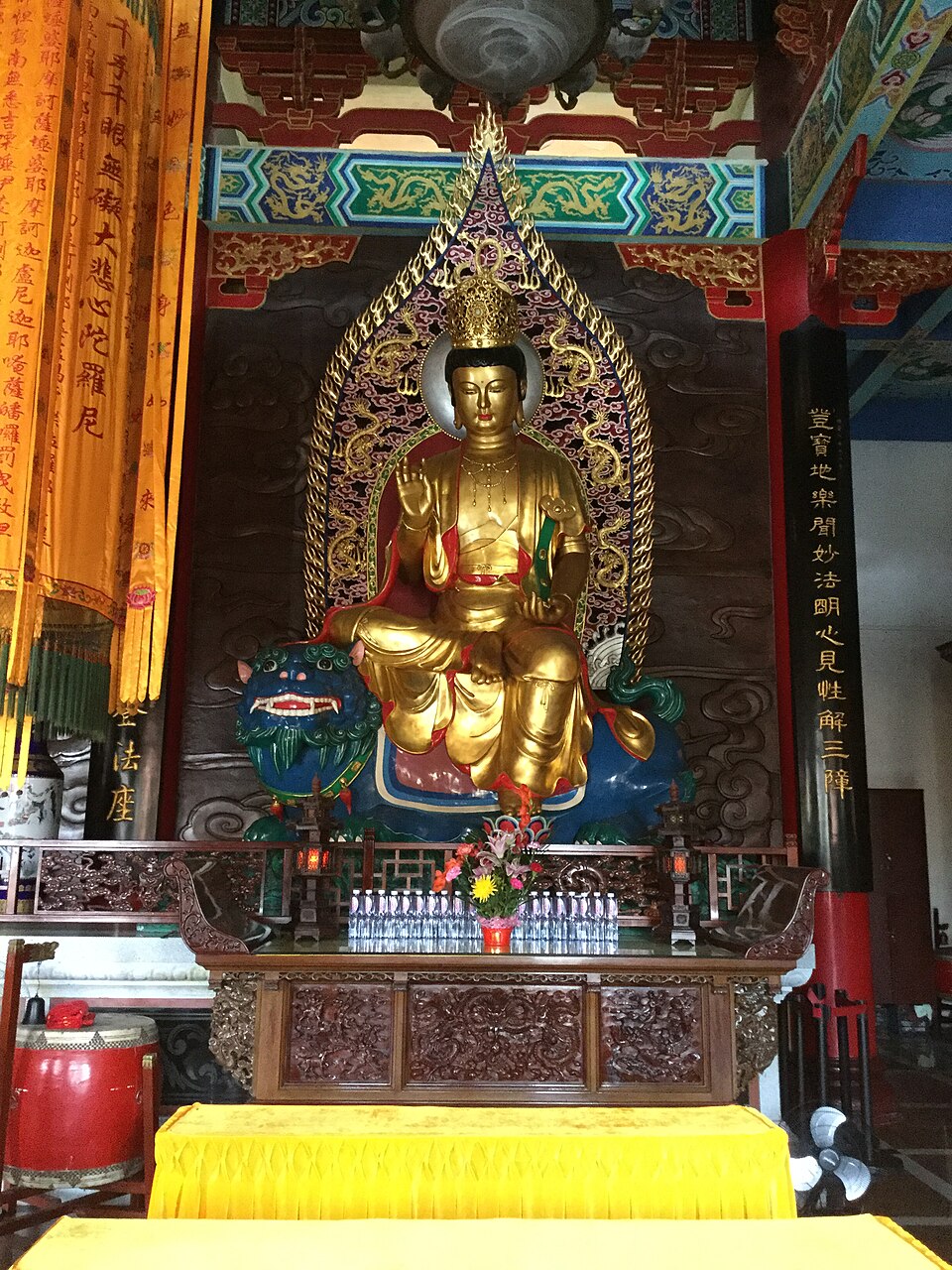 Statue of Bodhisattva Manjushri seated on his lion mount — the wisdom deity of Mahayana and Vajrayana Buddhism, subject of the text Aryamanjushrimulakalpa