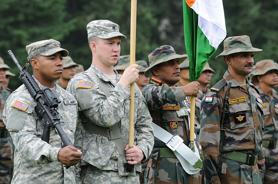 A joint colour guard of United States Army and Indian Army soldiers standing side by side, with the Indian tricolour carried between them