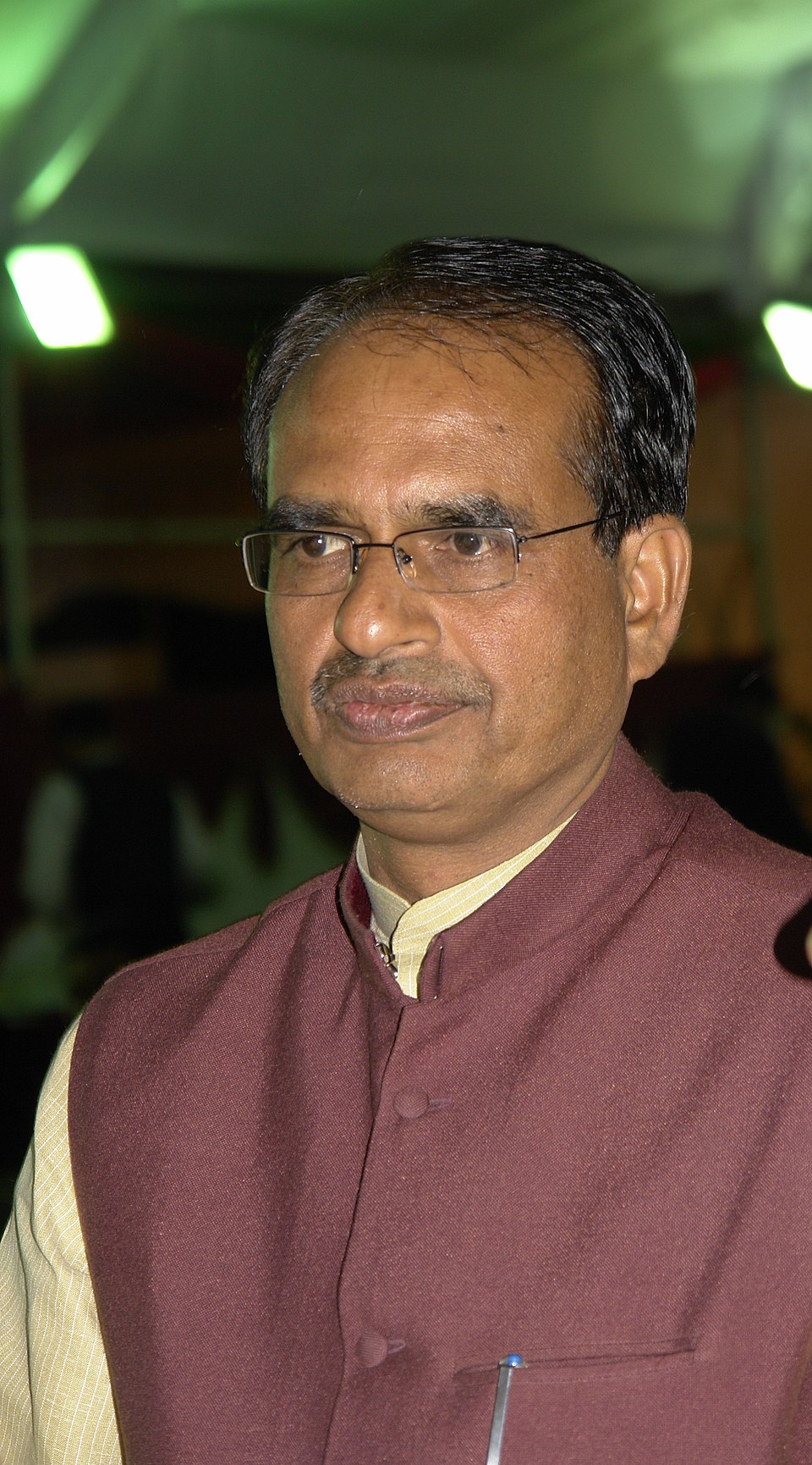 Portrait of Shivraj Singh Chouhan wearing a maroon Nehru jacket over a cream kurta