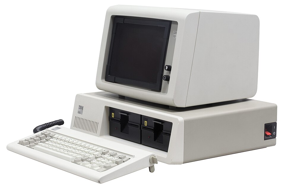 An IBM Personal Computer of 1981 with its monitor sitting on the system unit, twin floppy drives and a detached keyboard