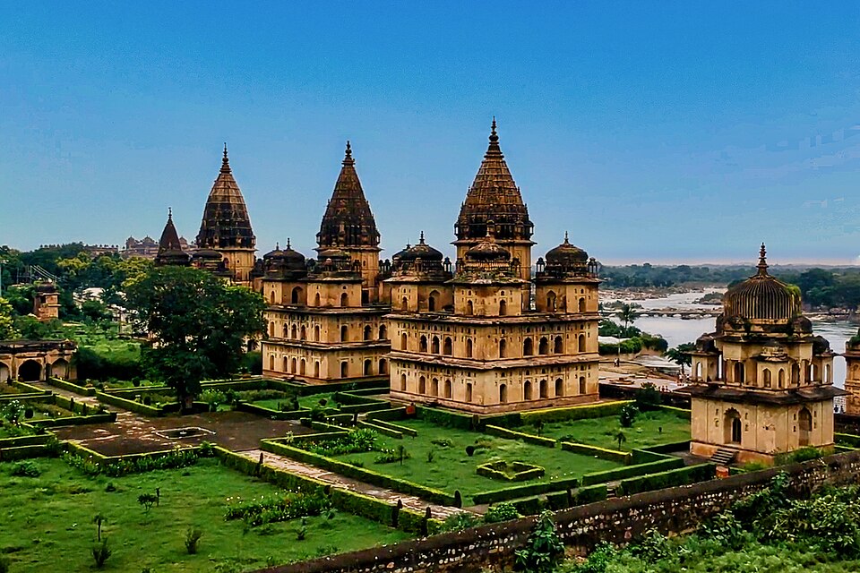 The tall spired Bundela chhatris at Orchha standing in walled gardens on the bank of the Betwa river