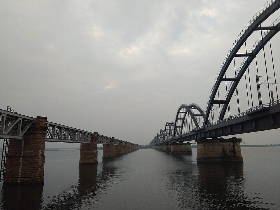 The wide Godavari river at Rajahmundry spanned by the old truss rail bridge and the newer steel arch bridge