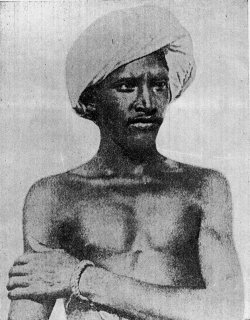 The historic photograph of Birsa Munda, a young man in a turban with a cloth over one shoulder