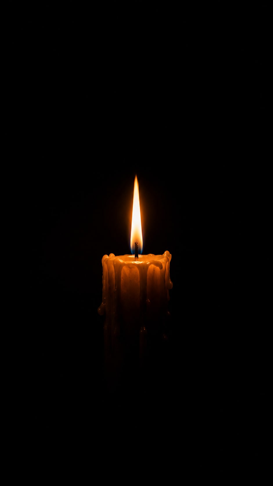 Single Candle in Darkness