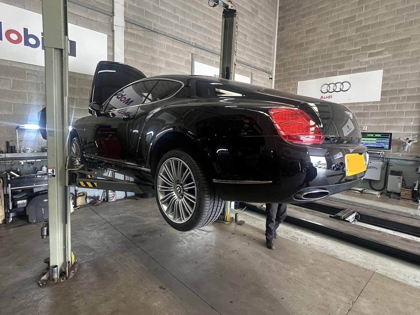 Bentley Continental GT raised on a lift for servicing at Mitsiland