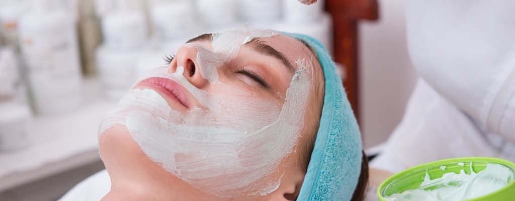 Lazy sloth lounges on couch, flipping television remote.