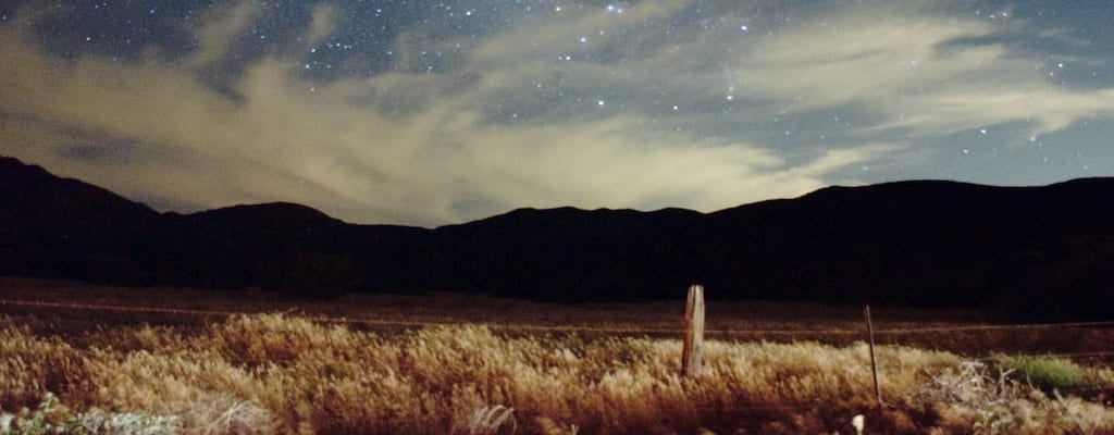 The moon rose over hills far away.