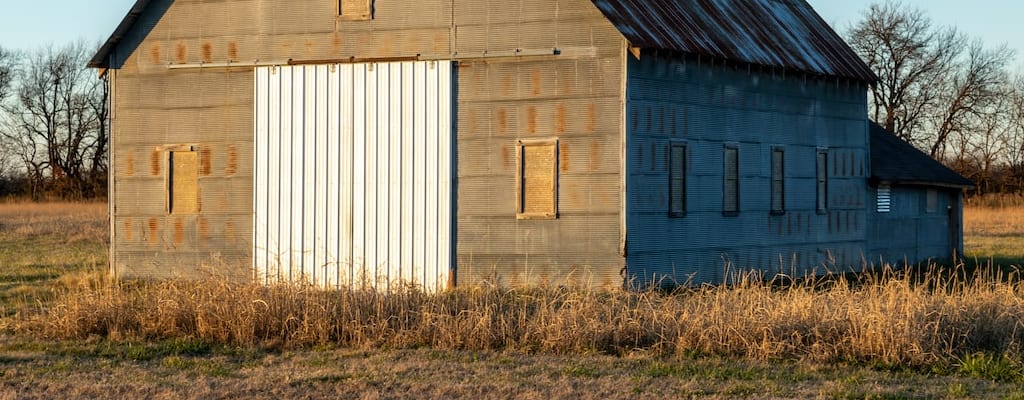 The pony grazed peacefully inside the barn.