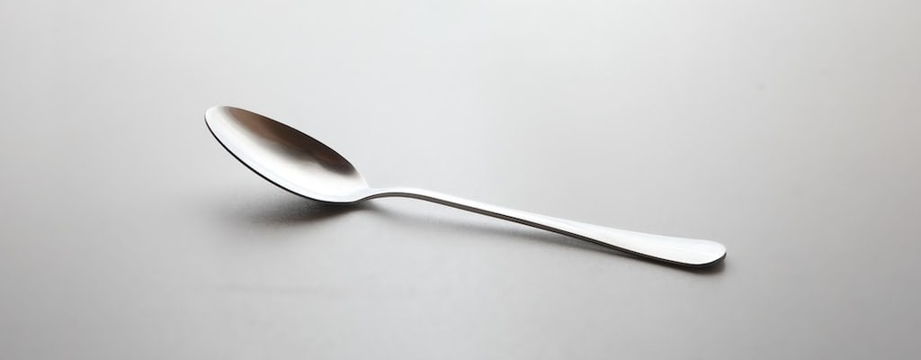 Silver spoon symbolizes wealth and privilege.