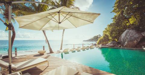 MyPlanet resor-Mahe-Carana Beach Hotel-Sunbeds by the pool.jpg