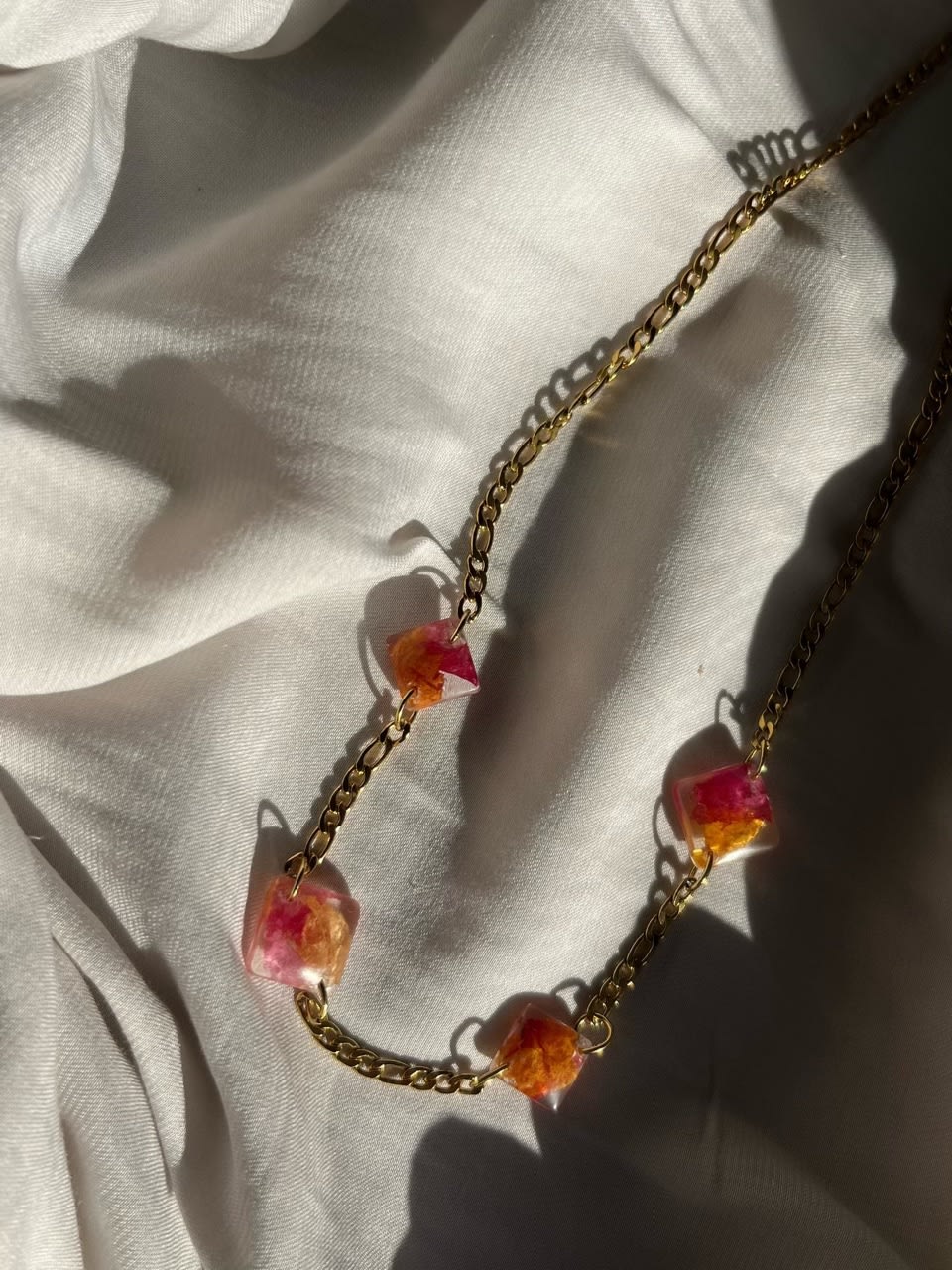 Real flower preserved in resin, paired with a stainless steel chain.