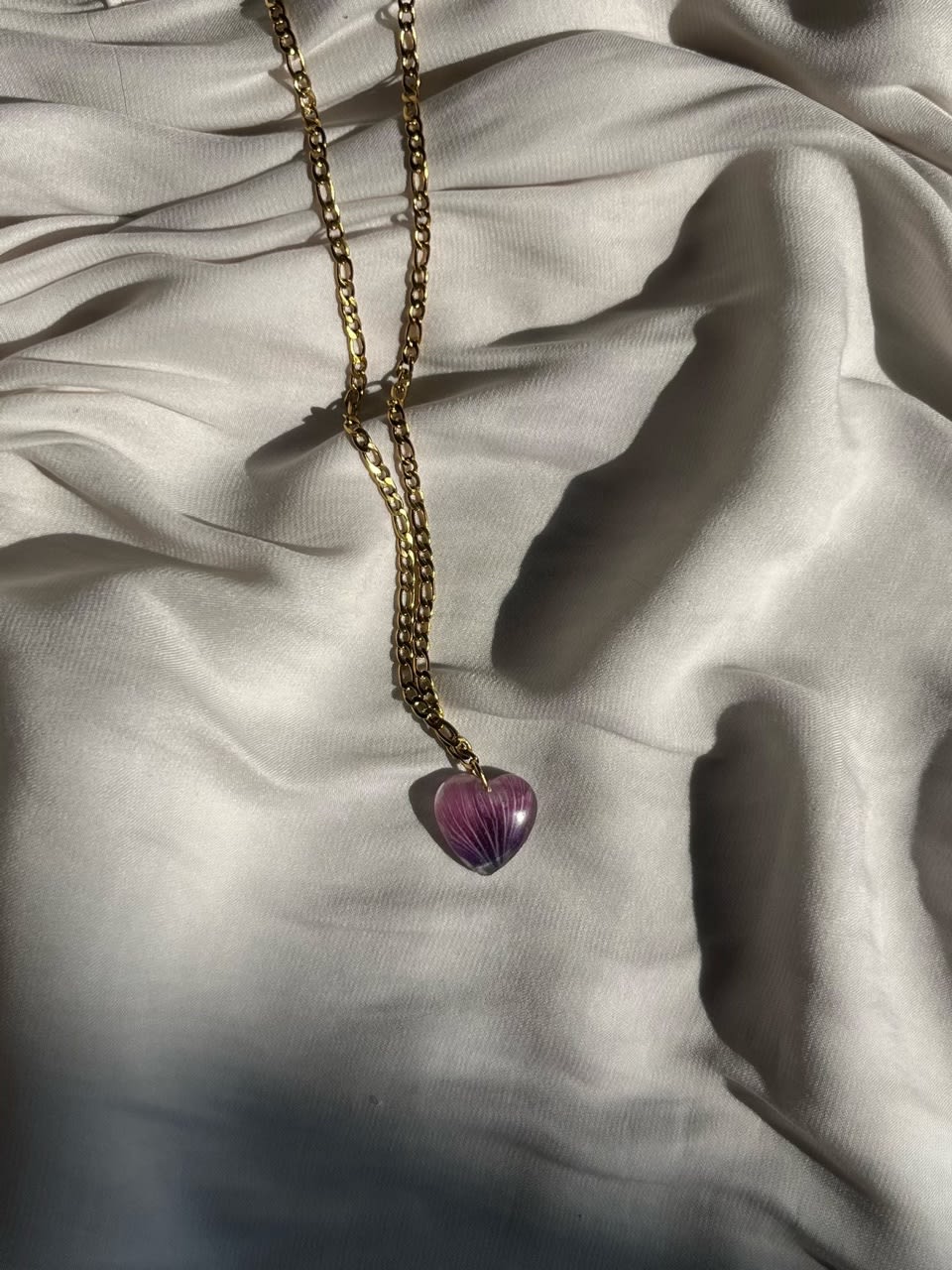 Pink heart necklace made with real flowers, resin, and stainless steel.