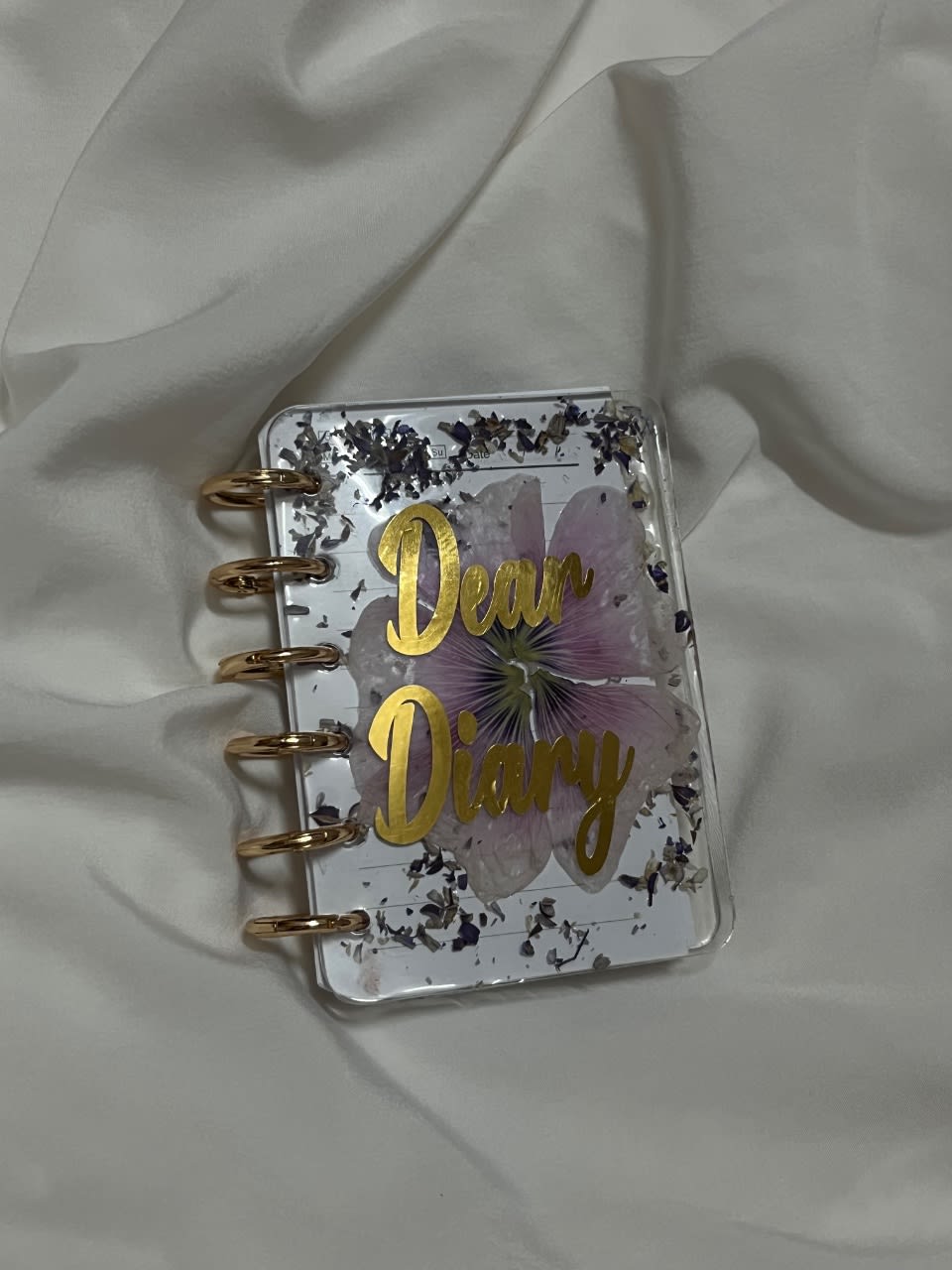 A dreamy “Dear Diary” notebook, made with real flowers preserved in resin.