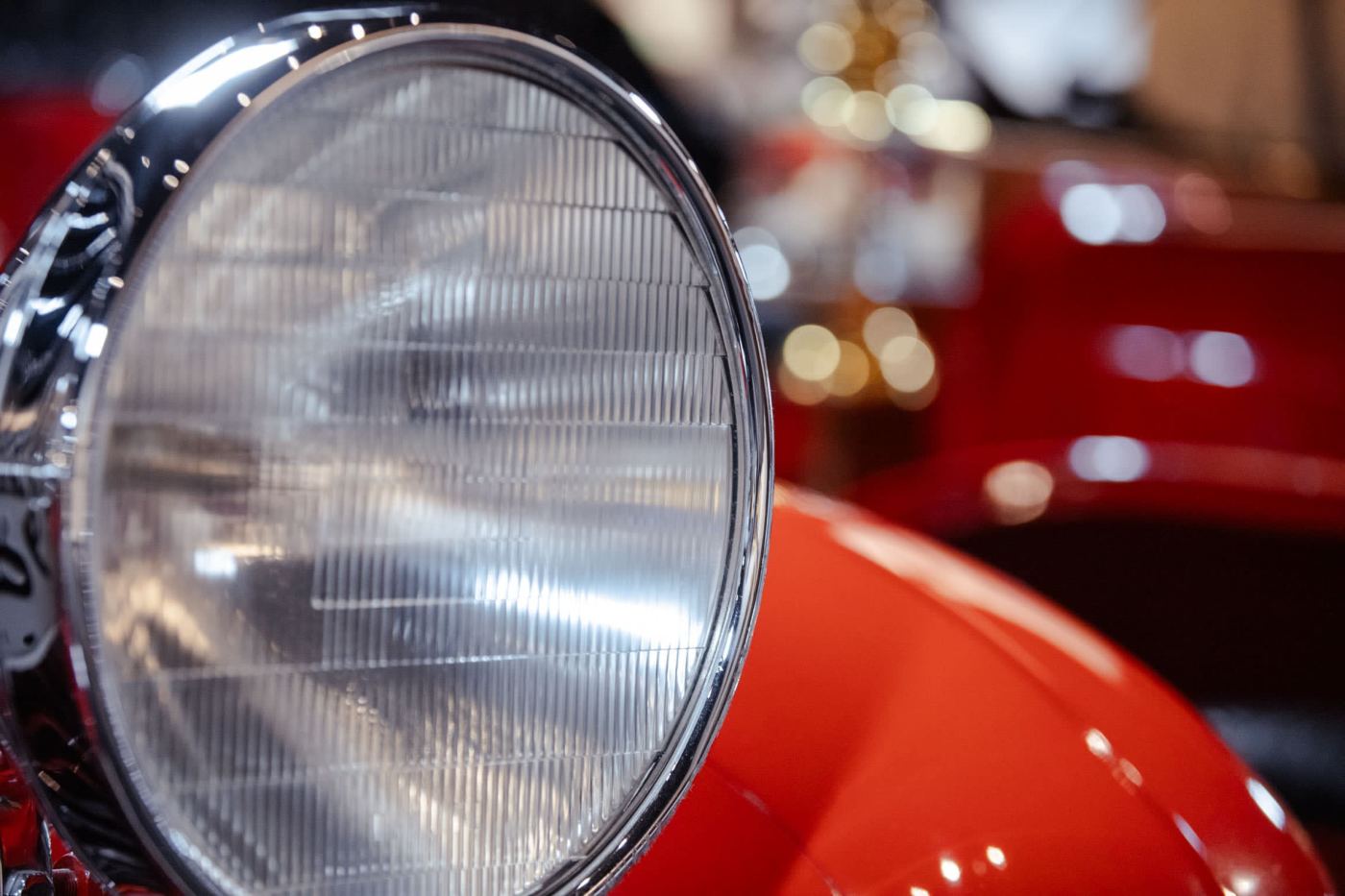 Ribbed-glass headlamp on red coachwork