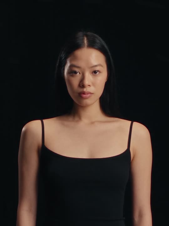 Alexandra Lim, in a black singlet against a black studio