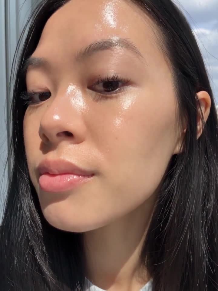Alexandra Lim, patting in a serum at the bathroom mirror, then a close-up of glowing skin, filmed on a phone