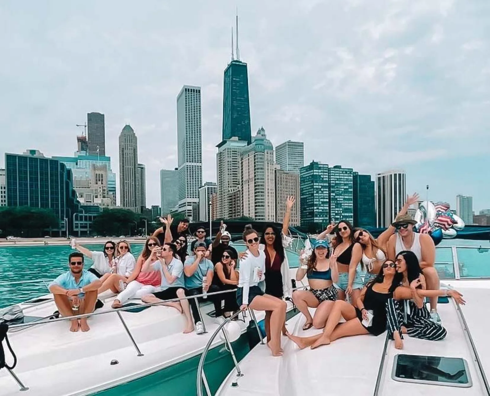 Two large groups of people sitting on two separate boats
